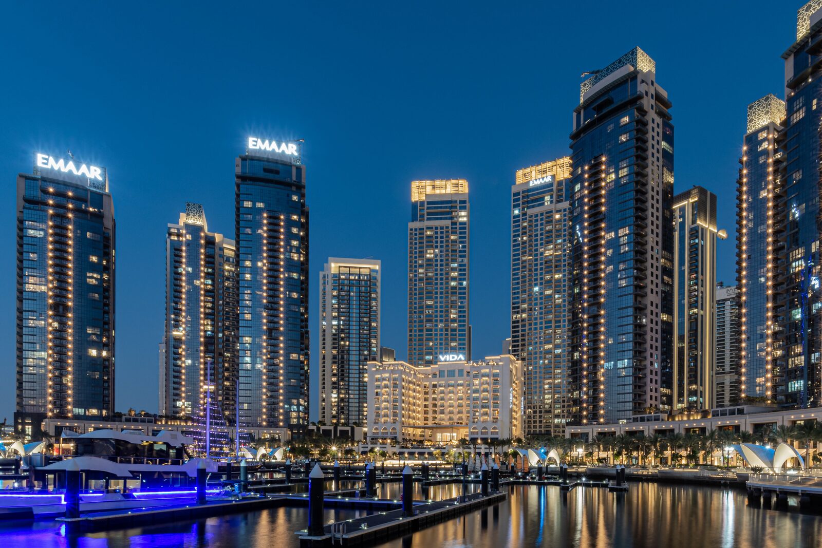 Dubai towers and waterfront illuminated at night
