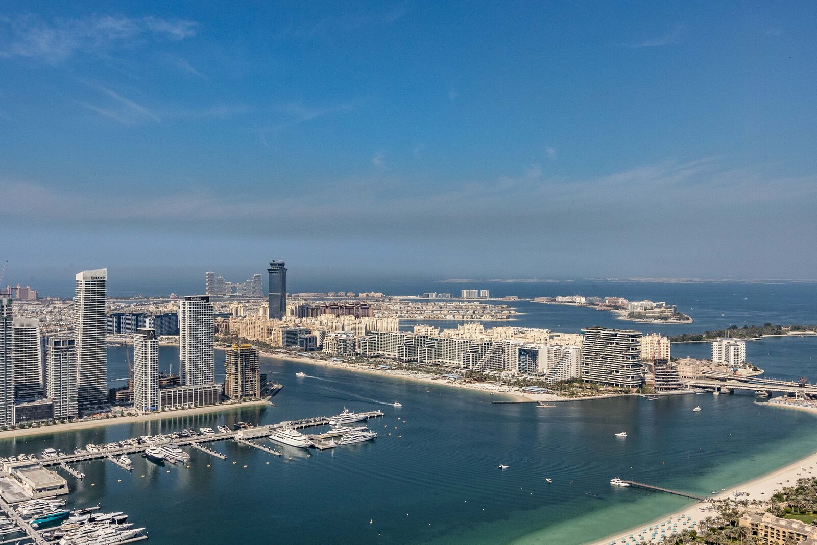 High-rise buildings beside a marina and coastline